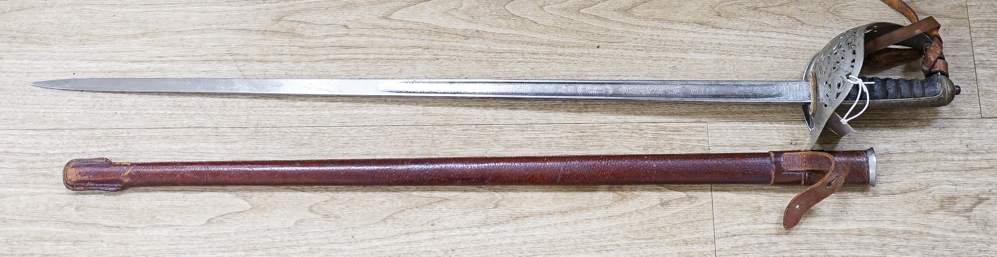 A George V Henry Wilkinson Royal Engineers dress sword with scabbard and cover, the blade etched GHL